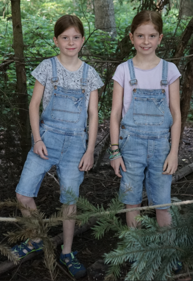 Die 9-jährigen Zwillinge Mia und Lynn spielen gerne im Wald.